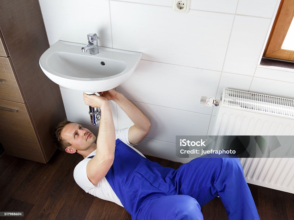 plumber repairs washbasin